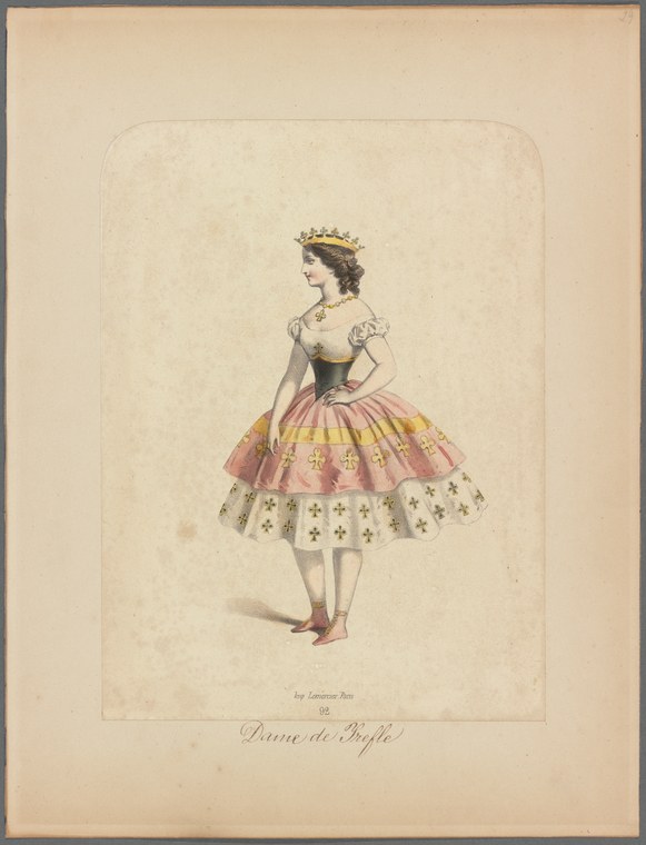 A woman in a black bodice and elaborate tiered skirt with pink and white ruffles, wearing a tiara and heeled slippers, stands in a formal pose.