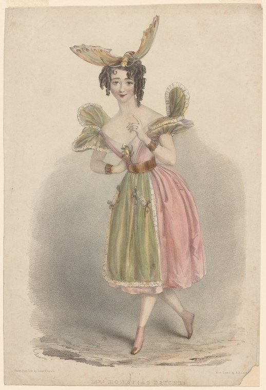 A barefoot woman in pink skirt and corseted bodice, wearing enormous iridescent fairy wings and a plumed headdress, stands in a classical ballet pose.