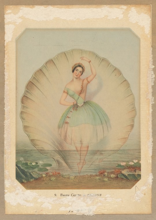 A young ballerina in a pale green tulle skirt stands en pointe inside a giant scallop shell, one arm raised gracefully overhead.