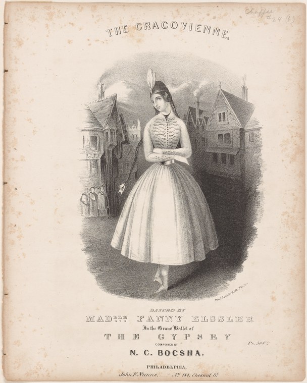 Woman in 1840s dress with fitted bodice and full skirt stands alone in a European street lined with tall buildings, posed upright with arms at her sides.