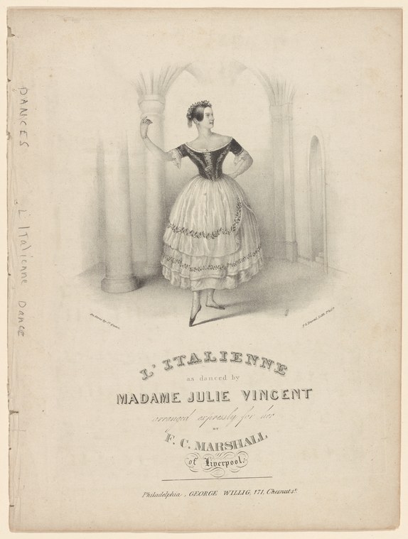 Woman in black bodice and white gathered skirt poses in balletic attitude in a columned interior, one arm raised.