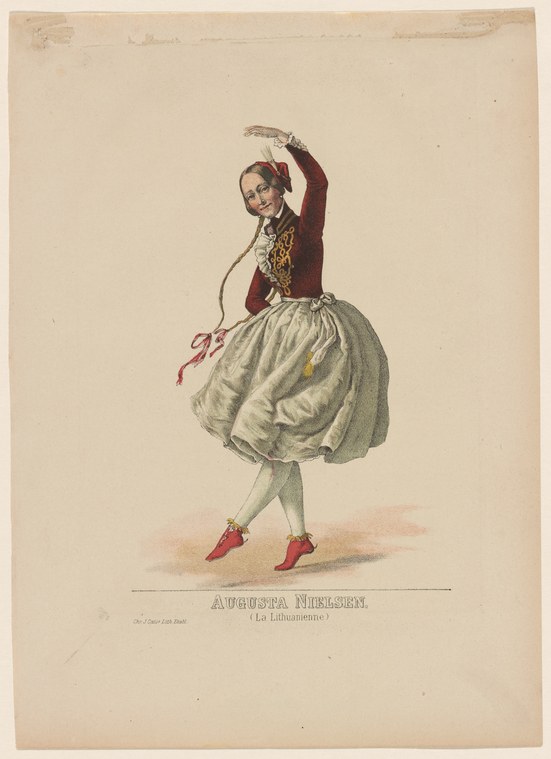 A woman in a burgundy velvet jacket and billowing gray skirt stands with one arm raised, holding a curved prop, in a classical ballet pose.