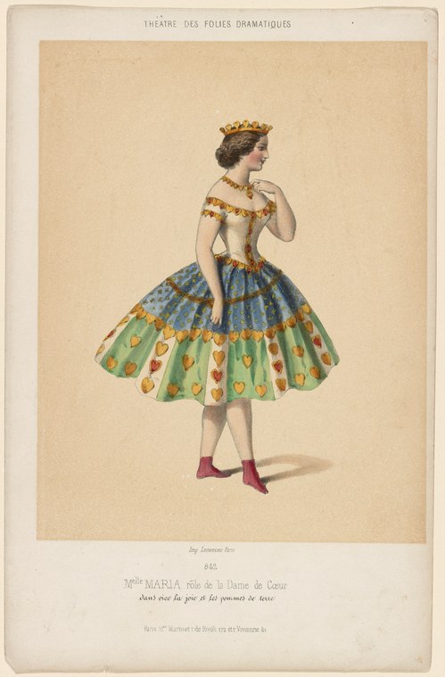 Woman in golden crown and cream tunic with wide blue-green heart-patterned skirt, standing in profile against cream background.