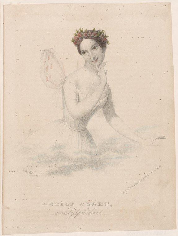 Lucile Grahn in ballet pose, barefoot in tulle skirt and flower crown, floating weightlessly with a butterfly wing prop in her raised hand.