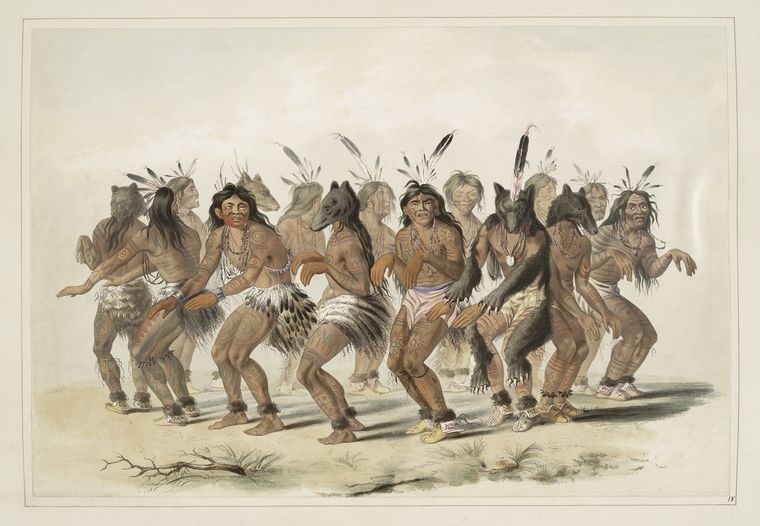 Ten male figures in feathered headdresses and ornamental dress stand in a line on bare ground, facing forward.