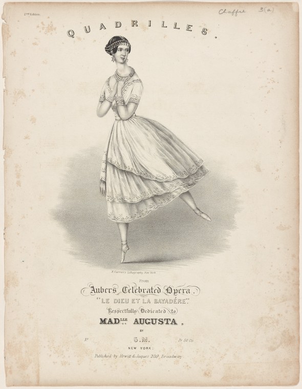 A woman in a white ruffled dress and upswept dark hair stands poised en pointe or demi-pointe, arms softly raised, in a lithographic theatrical souvenir print.