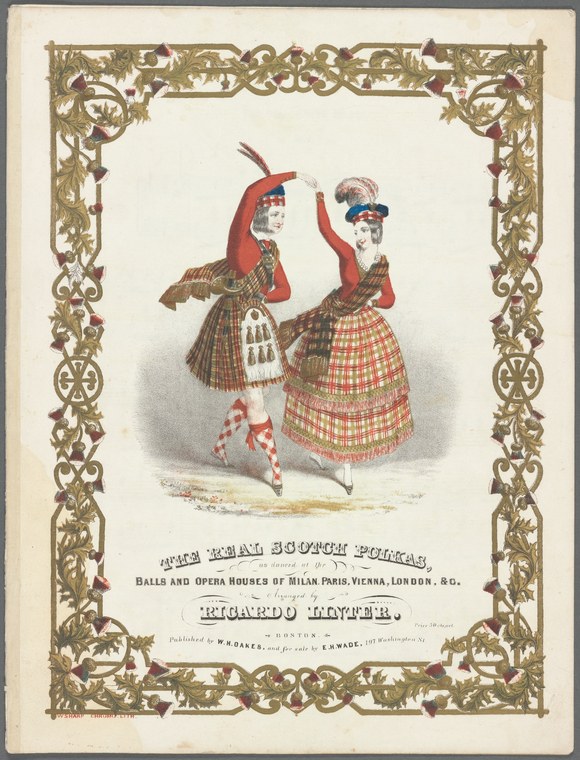 Two women in tartan skirts and red jackets perform a Scottish polka, captured mid-spin with raised arms and billowing skirts.