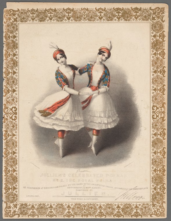 Two female ballet dancers in white tutus and feathered headdresses face each other with arms extended in a formal pose.