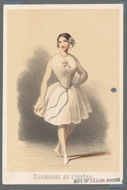 Young woman in pale Romantic-era ballet dress posed upright with raised arm, dark hair adorned with flowers, against shadowed theatrical background.
