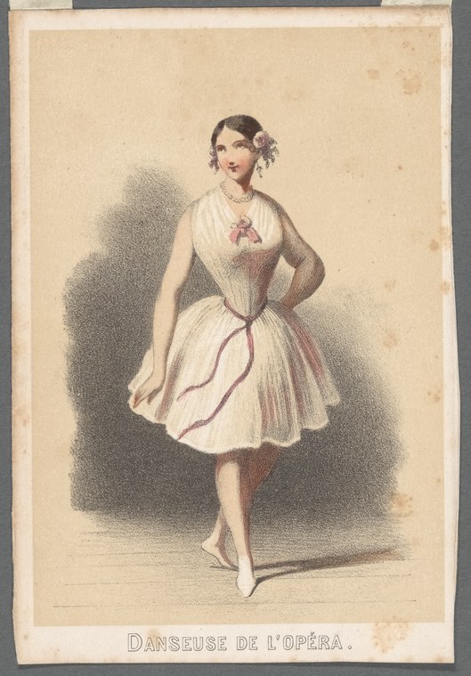 A female ballet dancer in a pale silk dress with purple waist ribbon stands in poised position wearing soft ballet shoes.
