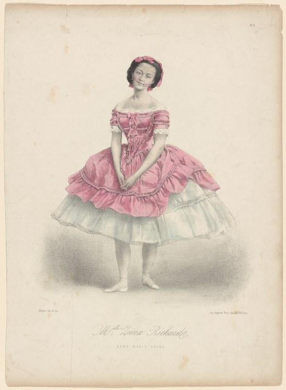 Young female dancer in rose-pink Romantic tutu and off-shoulder bodice, standing alone in a portrait pose against a neutral background.