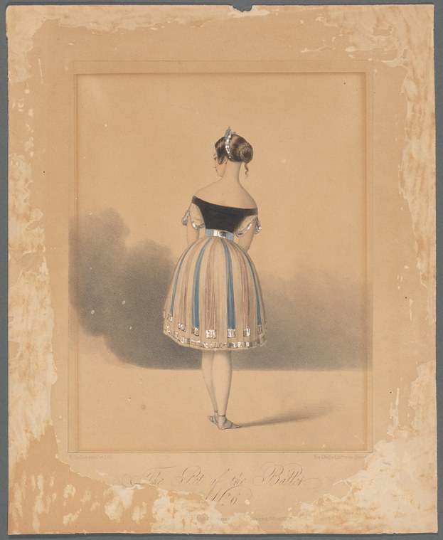 A young woman in a black off-shoulder bodice and pale tulle skirt stands facing away, in relaxed pose against a plain background.