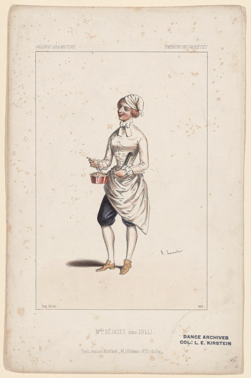 A woman in 18th-century theatrical dress stands poised against a plain background, holding a small object, wearing an upswept cap and pale gown with dark