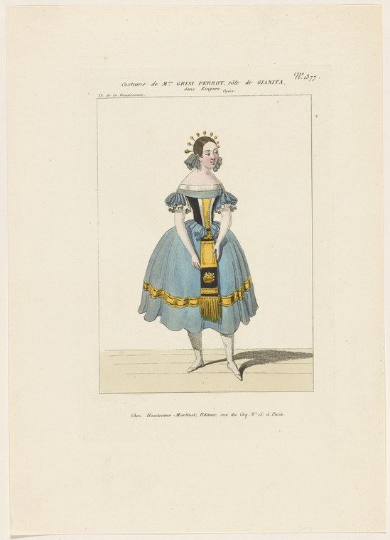 Woman in pale blue tiered skirt with gold trim, white puffed sleeves, gold bodice sash, and tiara, standing in balletic pose.