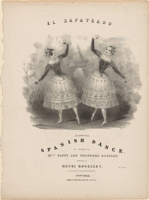 Two women in matching white skirts and dark bodices face each other with raised arms in a spirited dance pose.