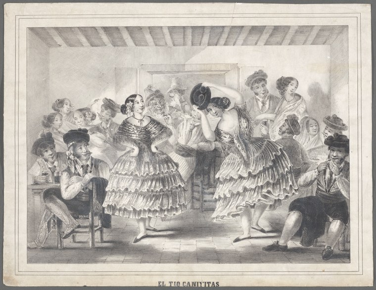 Two women in tiered ruffled skirts dance energetically while a guitarist plays and spectators watch closely in a crowded indoor scene.