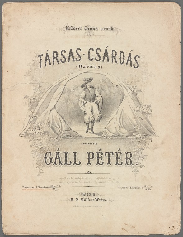 A man in white shirt and dark breeches stands poised beneath a tent, weight settled, arms relaxed, awaiting the music for a Hungarian csárdás.