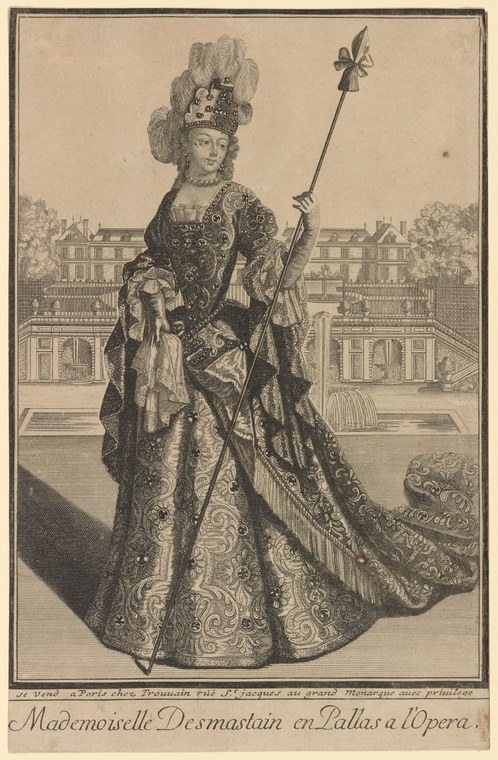 Woman in elaborate 18th-century court dress holding a fleur-de-lis staff, posed formally in front of the Palais de l'Opéra in Paris.