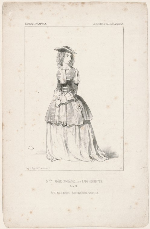 A young woman in a romantic-era ballet costume with a fitted bodice, puffed sleeves, and full skirt, standing in formal pose.