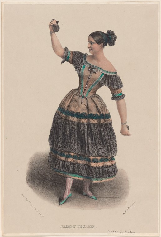 A woman in a dark silk dress with emerald-green trim stands in a graceful pose, her left arm raised, wearing pointe shoes and a short tiered skirt.