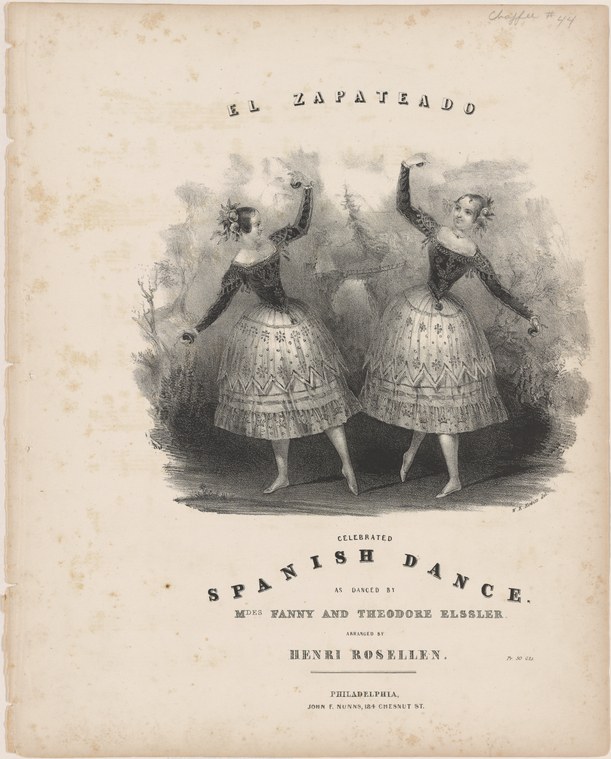 Two young women in matching white skirts and dark bodices stand side by side with arms raised overhead, leaning backward in synchronized poses.