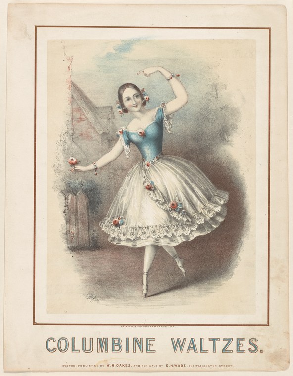Female dancer in pointe and tulle, arms reaching upward, one leg extended, wearing blue bodice with red flowers, white full skirt, against dark architectural