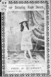 Woman in Victorian dress performing a high-leg skip with rope, captured at peak of jump in studio photograph.