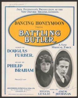 1922 theater poster for 'Dancing Honeymoon' film, with two oval portrait photographs of performers against golden background.