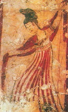 Faded fresco of a female dancer in a red pleated skirt with arms raised, head tilted back, mid-turn against an ochre ground.