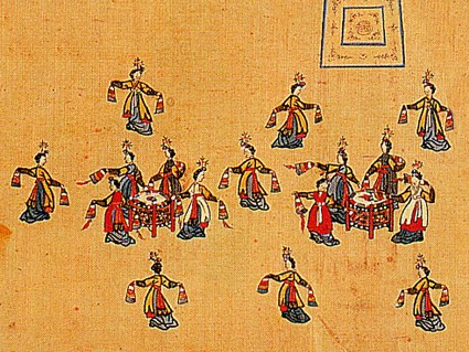 Twenty dancers in red silk robes holding large barrel drums stand in formal arrangement on a gold ground, documented as mugo court drum dance.