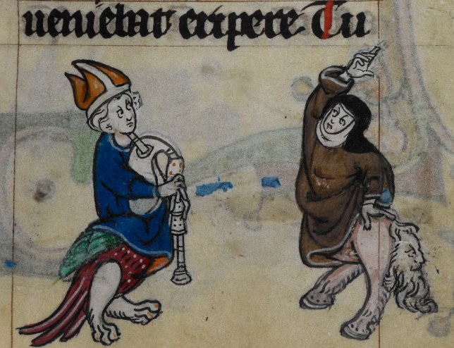 Medieval manuscript detail: a bishop playing bagpipes and a lion in monastic robes dancing in response.