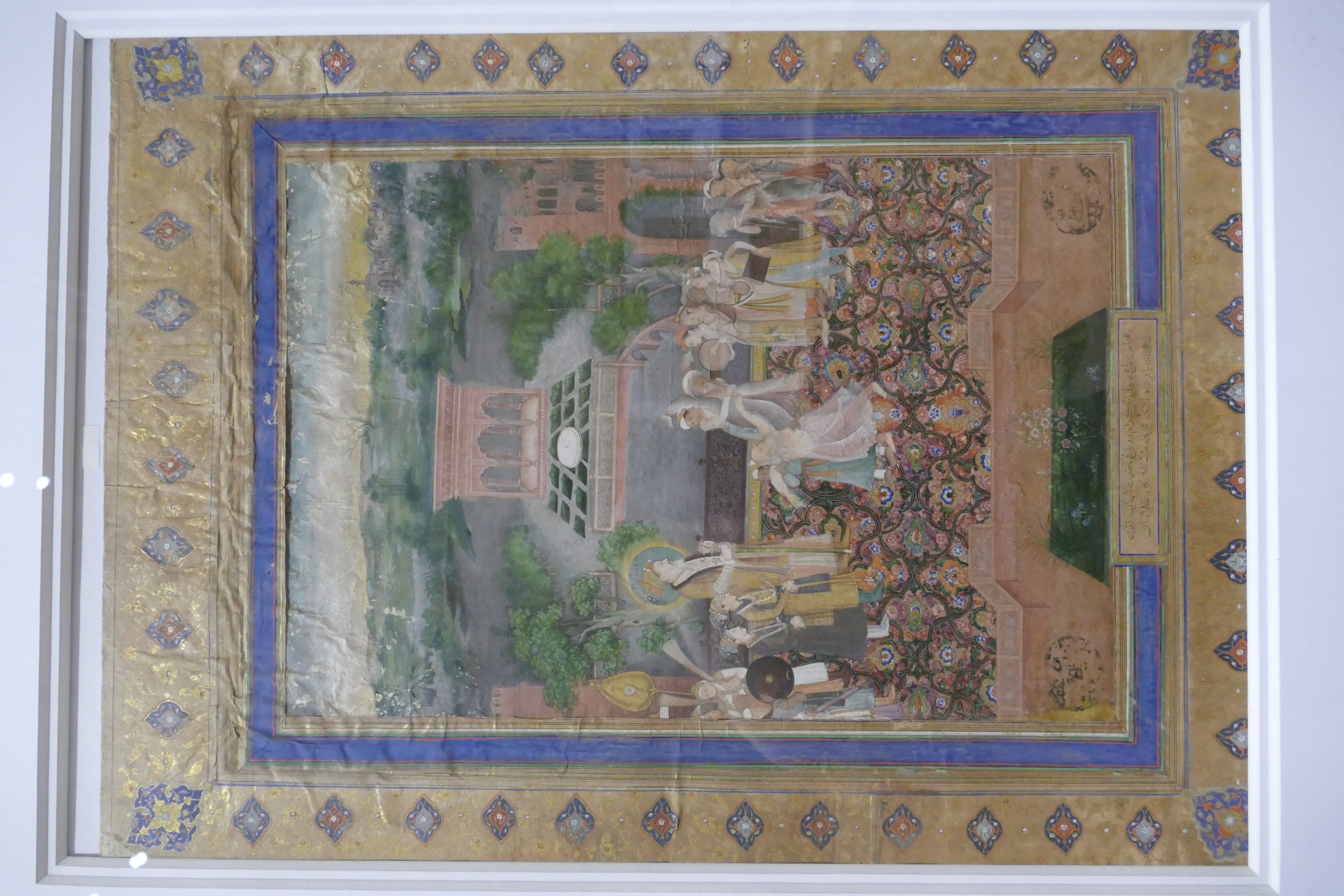 Mughal manuscript painting showing Emperor Shah Jahan seated and observing Sufi dancers with raised arms in ecstatic movement within an ornate palace courtyard.