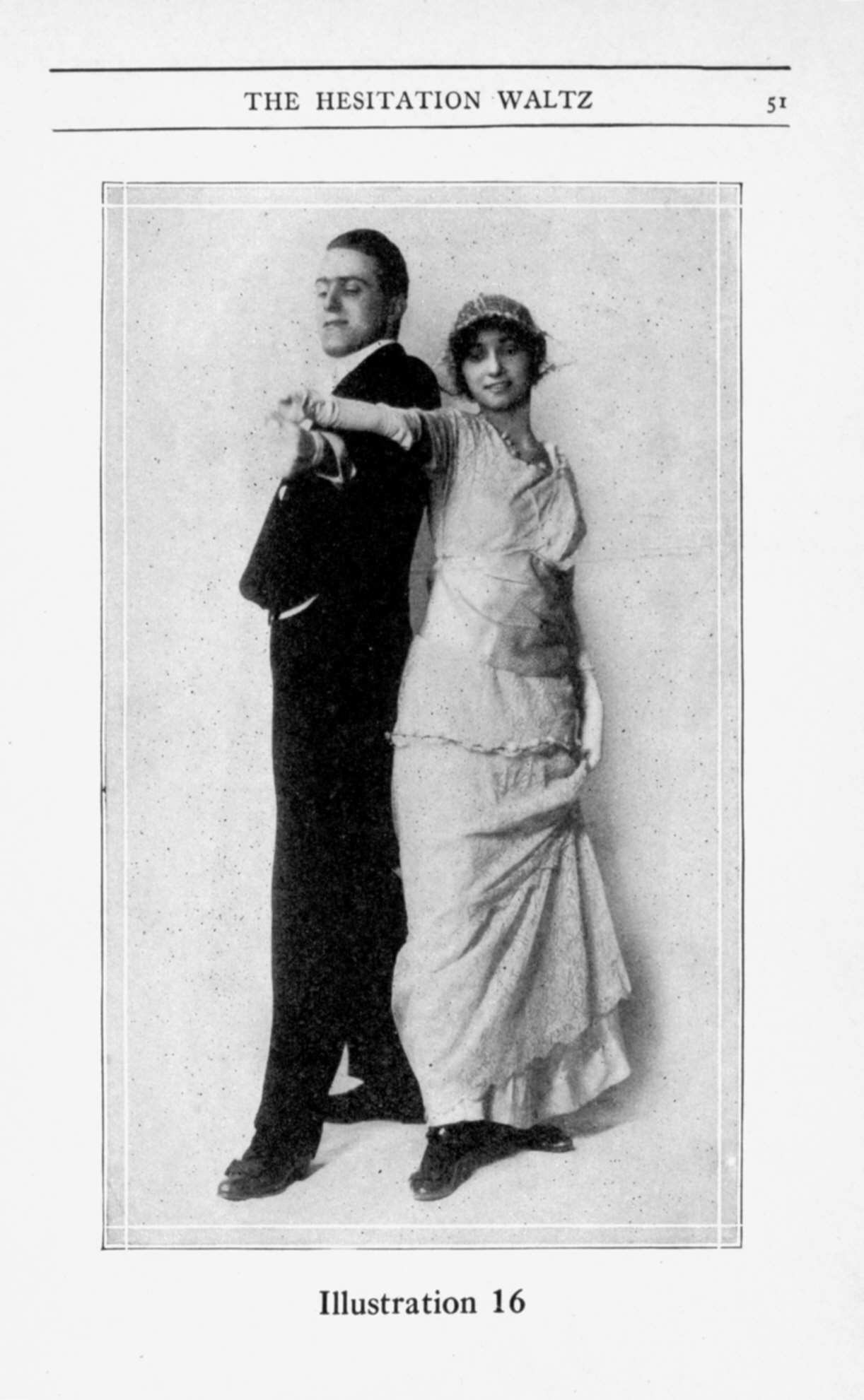 Man in dark jacket and white shirt and woman in pale pleated dress pose in ballroom waltz position in a studio photograph.
