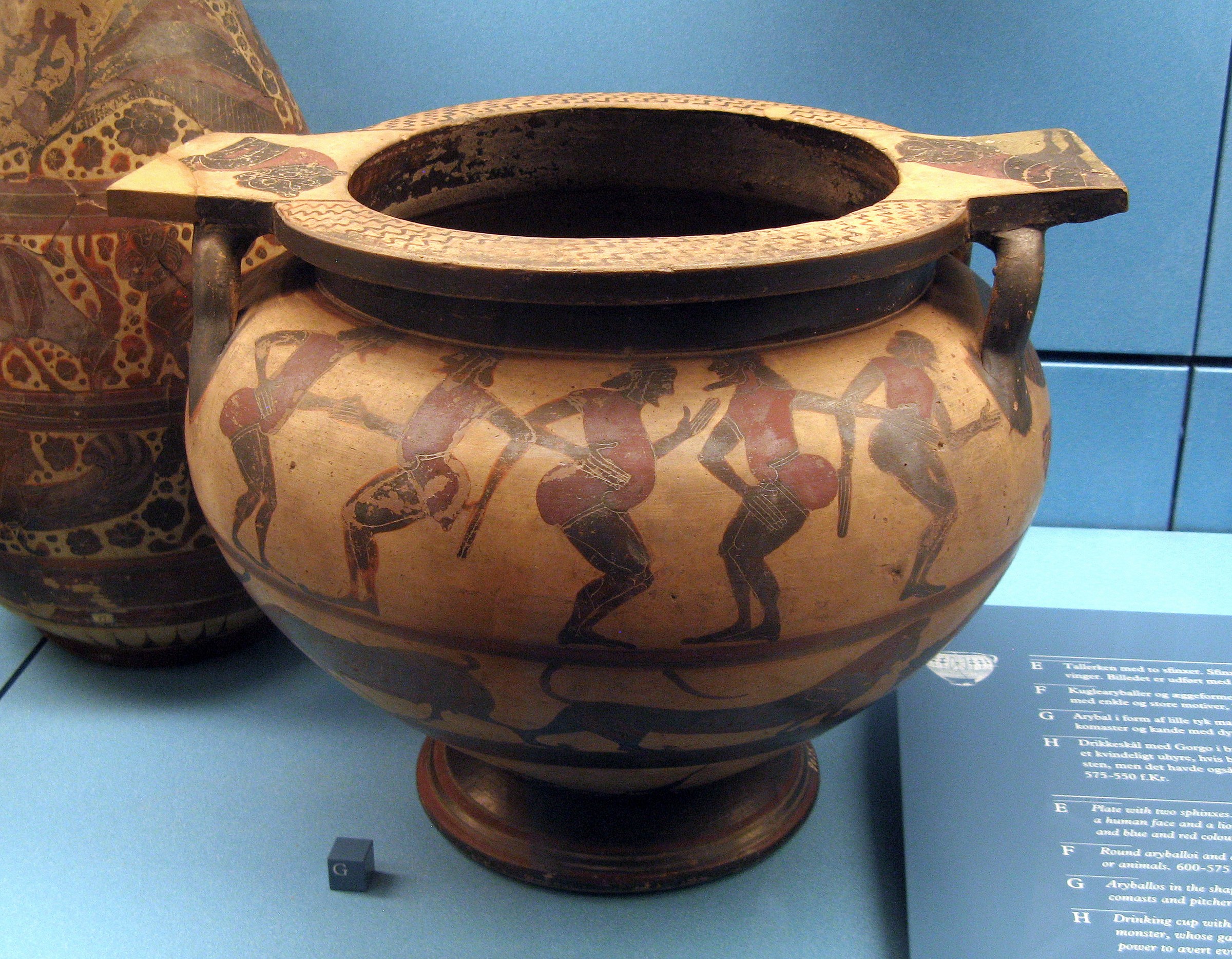 Ancient Greek terracotta krater with five nude male figures in identical deep squat poses around the body, rendered in red-figure technique.