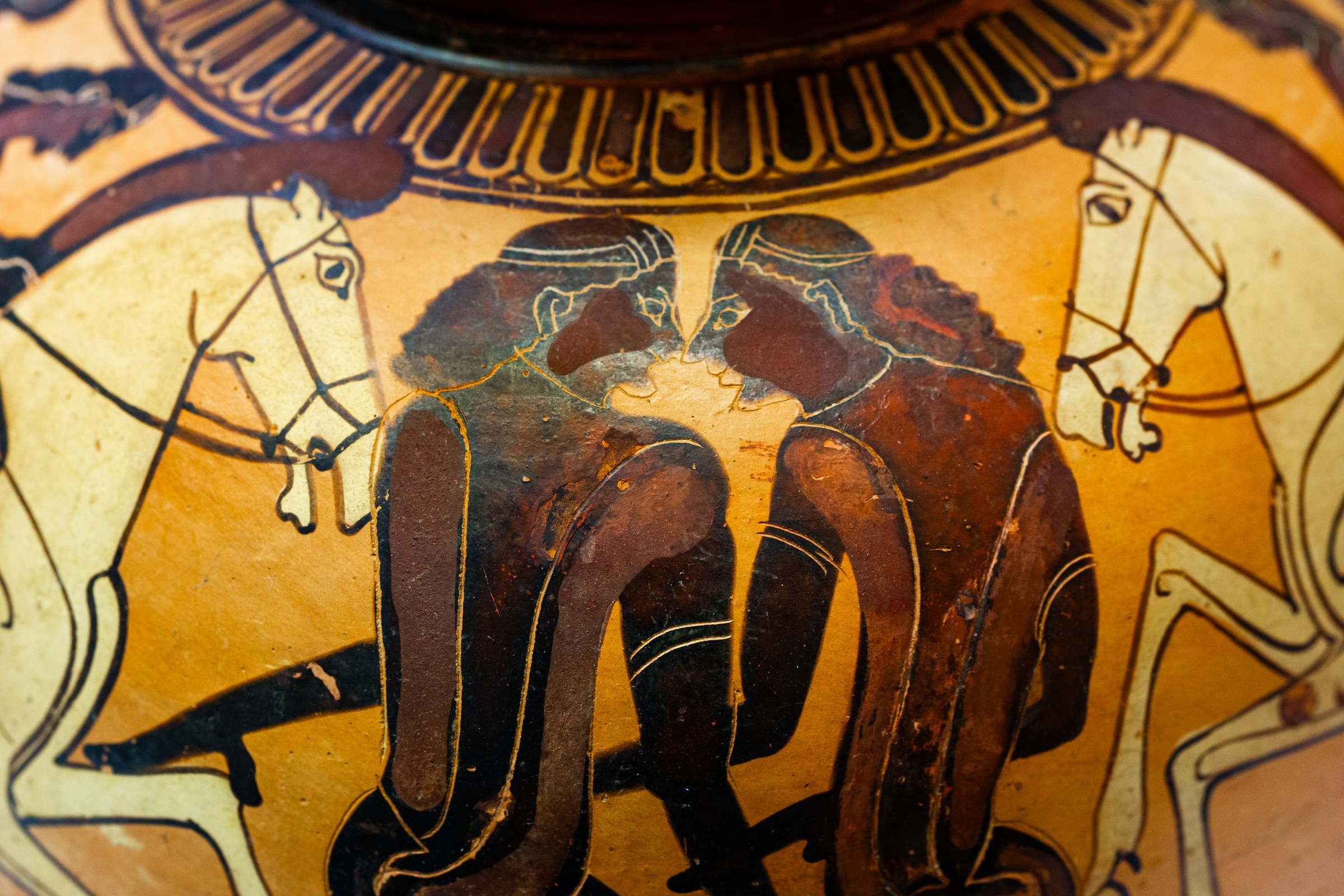 Greek vase with two padded male dancers in central poses flanked by young horsemen; eagles above; black-figure technique