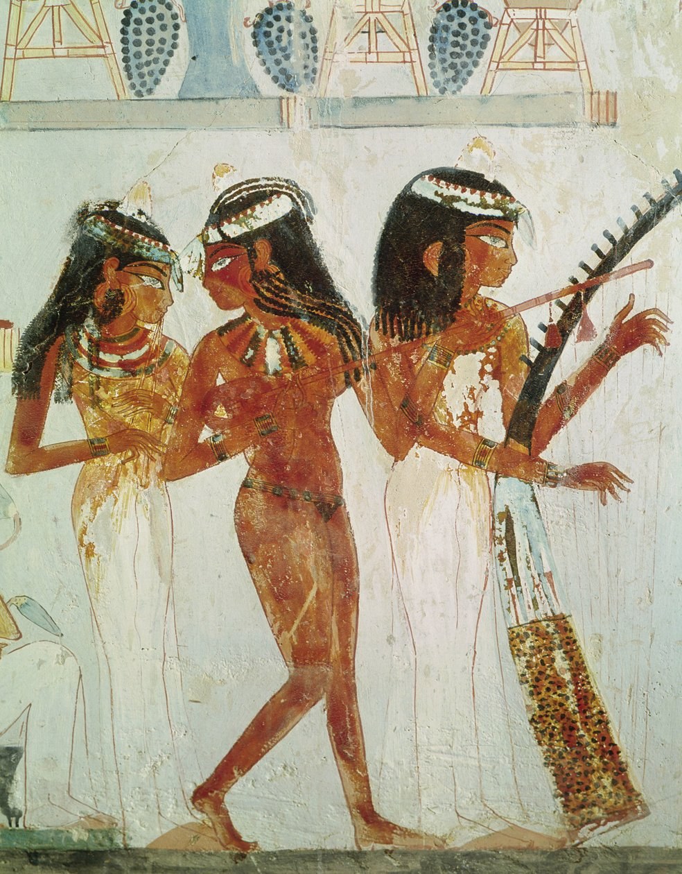 Three robed Egyptian women in profile: two holding musical instruments, one with an open hand gesture; gold collars and jeweled ornament; above them, a garden