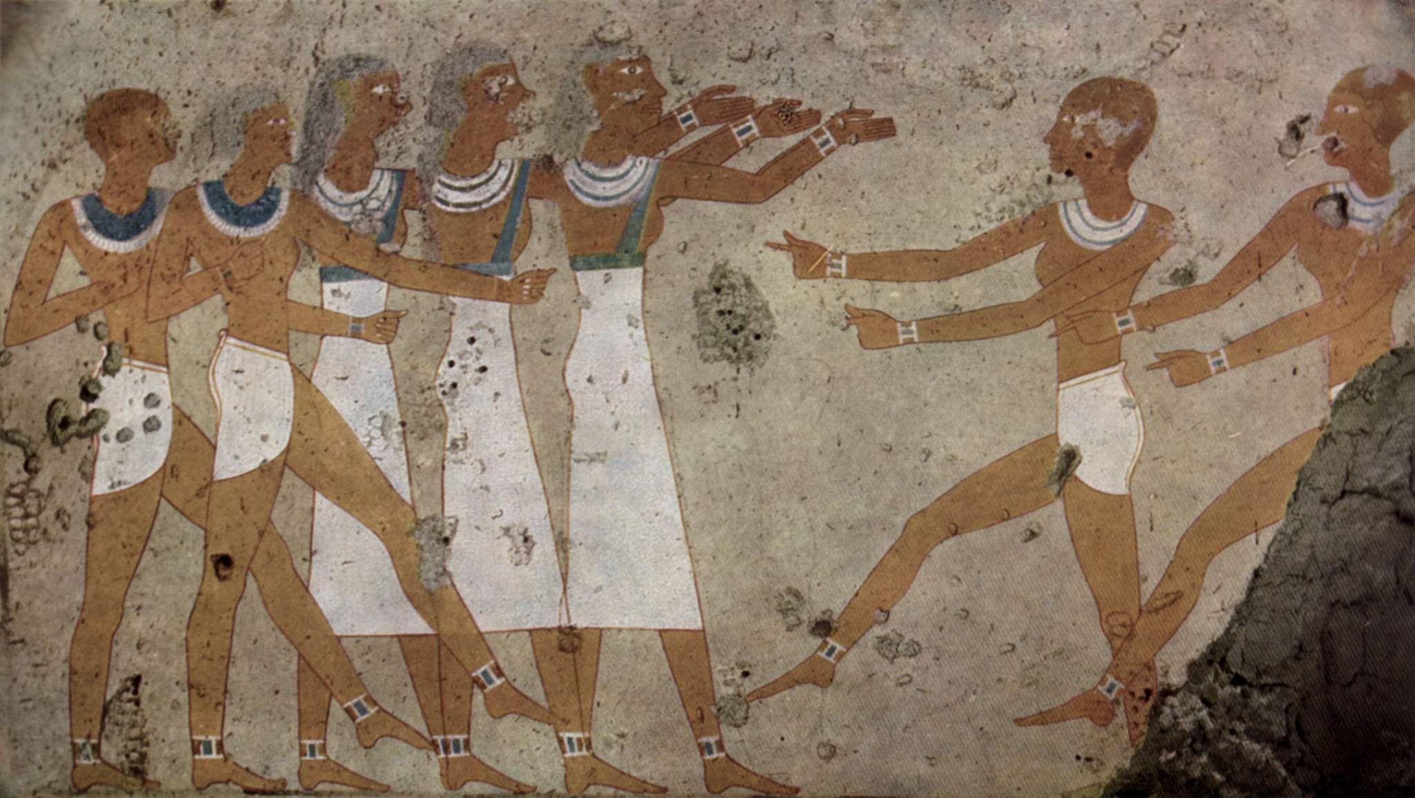 Eight ancient Egyptian men in white kilts and broad collars stand in profile, arms raised and extended in synchronized ritual gestures, arranged in a formal