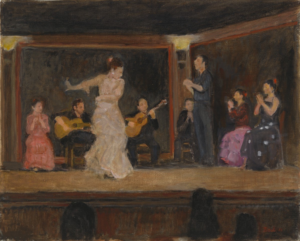 A bare-shouldered female flamenco dancer in a cream dress, arched backward, performs on a small stage with two guitarists. Audience members in colored clothing