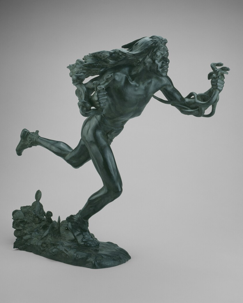 Bronze sculpture of a leaping male figure with streaming hair, arching backward, grasping serpents raised in both hands.