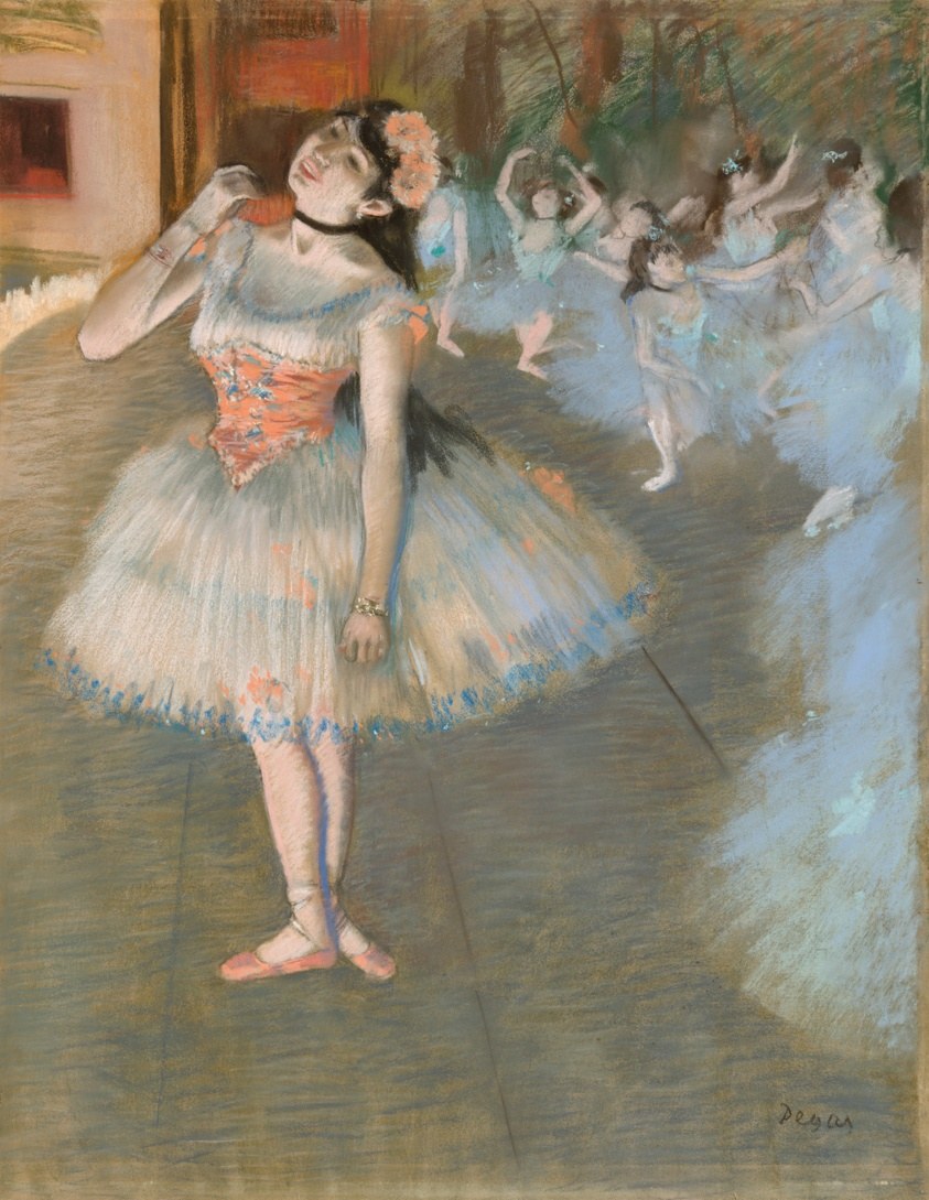 A weary principal ballerina in a pale blue tutu and orange corset stands with her head tilted back, arm raised, surrounded by corps dancers in a studio.