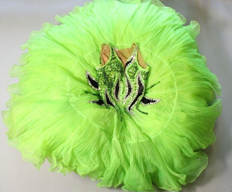 Lime-green tulle skirt with beaded chest ornament, photographed from above against a white background.