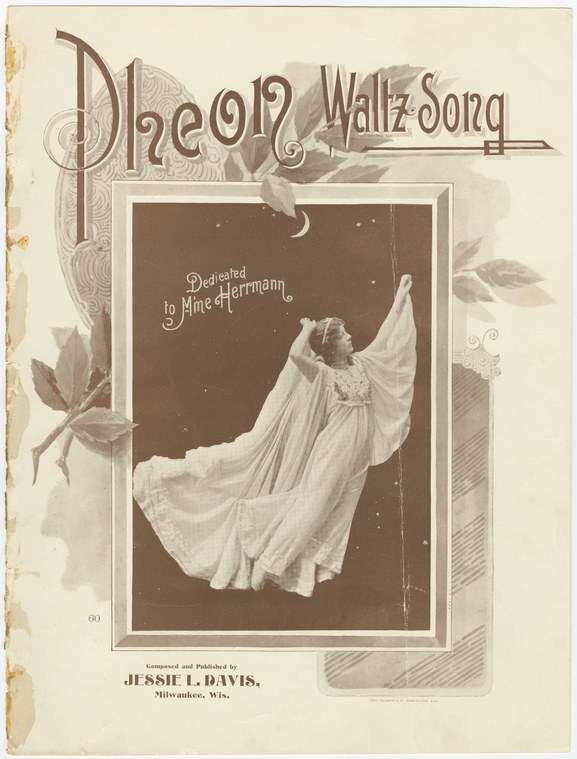 Woman in white flowing gown with arms raised, head tilted back, surrounded by brown art nouveau borders. Sheet music cover.