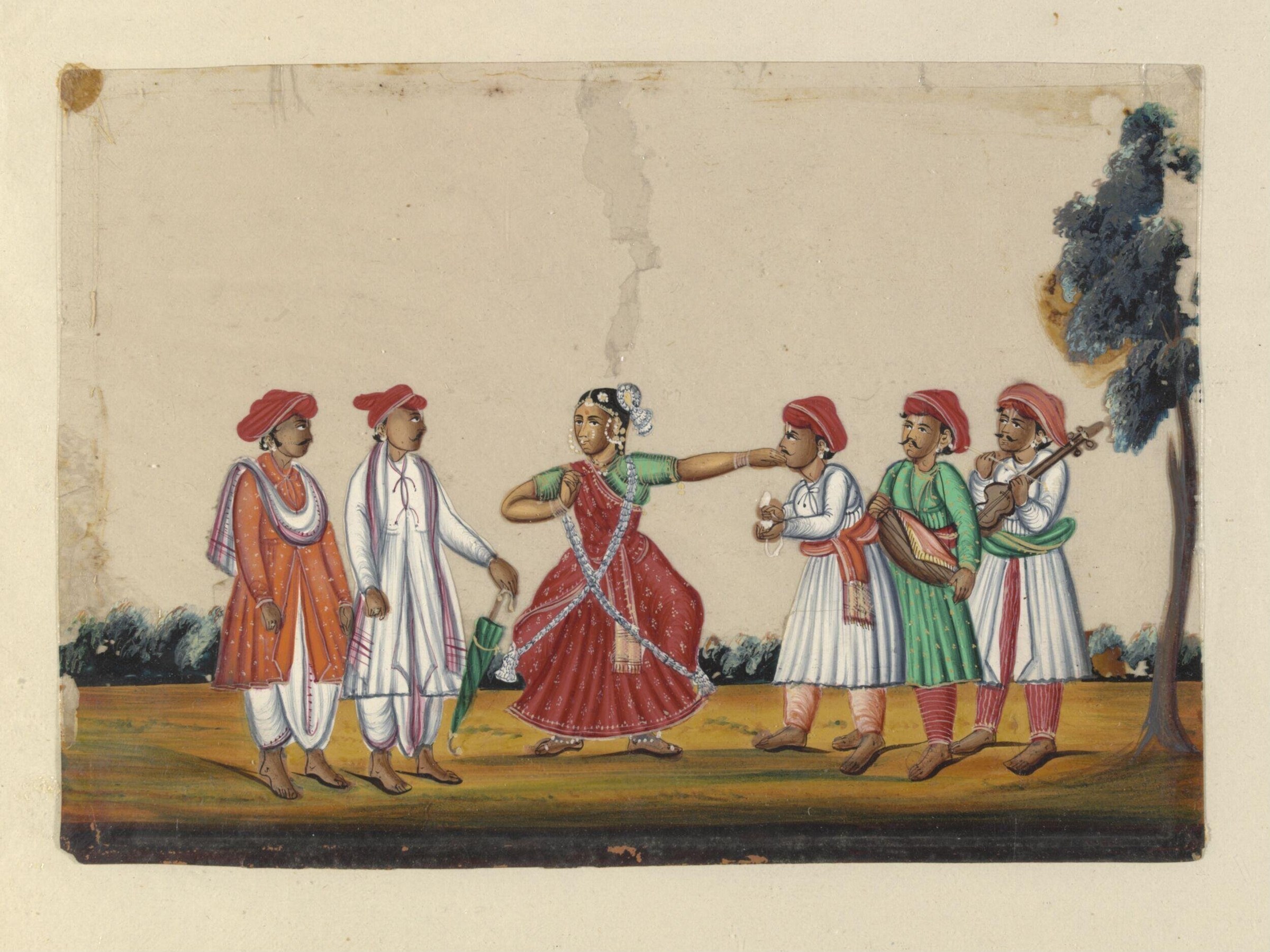 A woman in a red embroidered garment and jeweled headdress performs a graceful gesture for five men in turbans gathered around her in a courtyard.