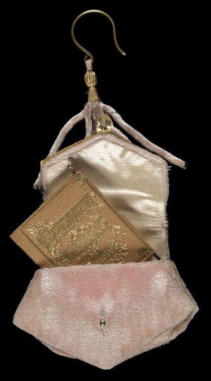 Layered purse of cream silk, embossed gold metallic fabric, and mauve suede with brass hook, circa 1890.