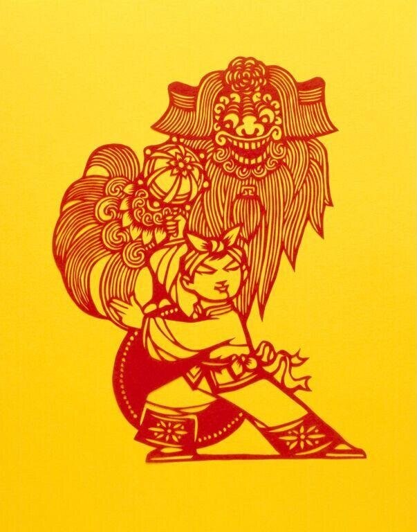 Red and gold papercut of a dancer in a wide-legged stance wearing an enormous ornate theatrical headdress shaped like a smiling mask.
