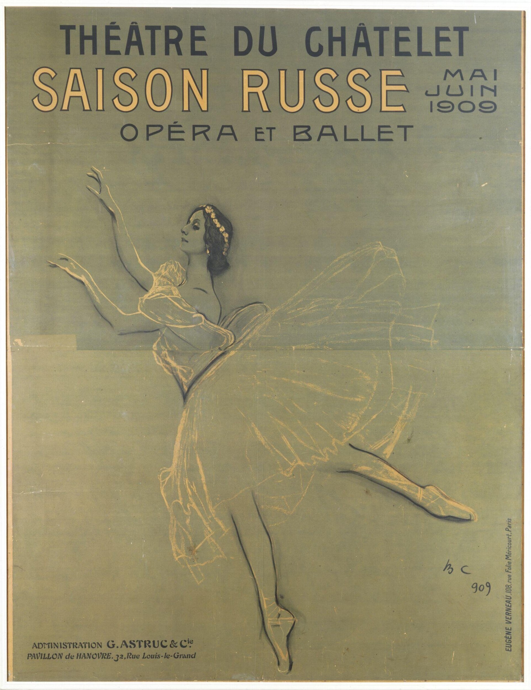 Female ballet dancer in golden tutu and shawl, posed in classical ballet position with one leg extended and arms raised.