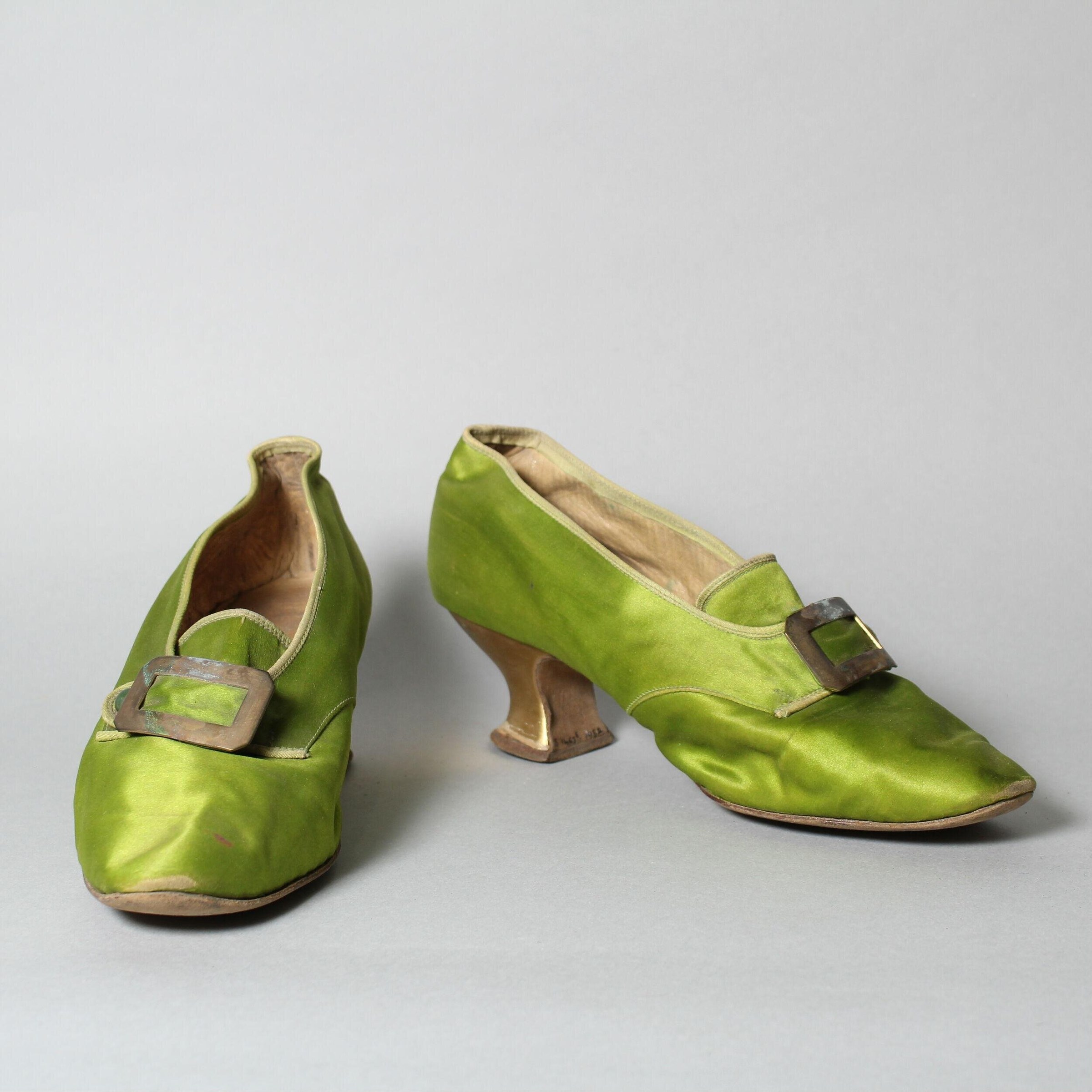 Pair of lime-green silk heeled shoes with gathered fabric uppers and metal buckles, shown from two angles.