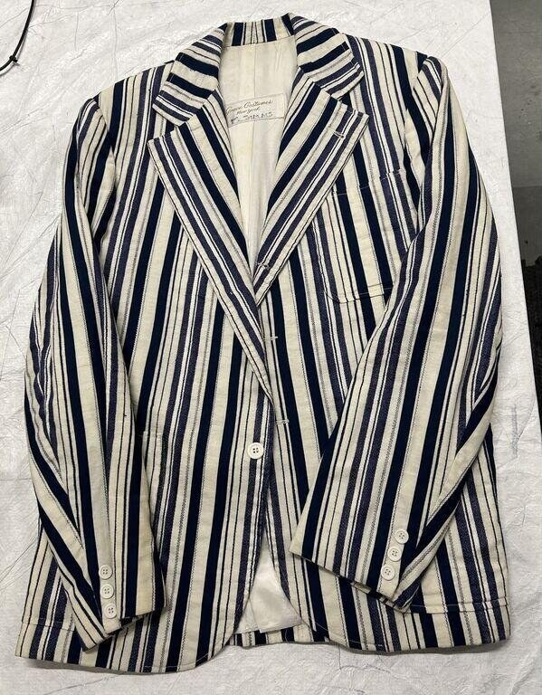 Navy and cream striped tailored blazer with diagonal stripes across the front panels, laid flat and photographed from above.