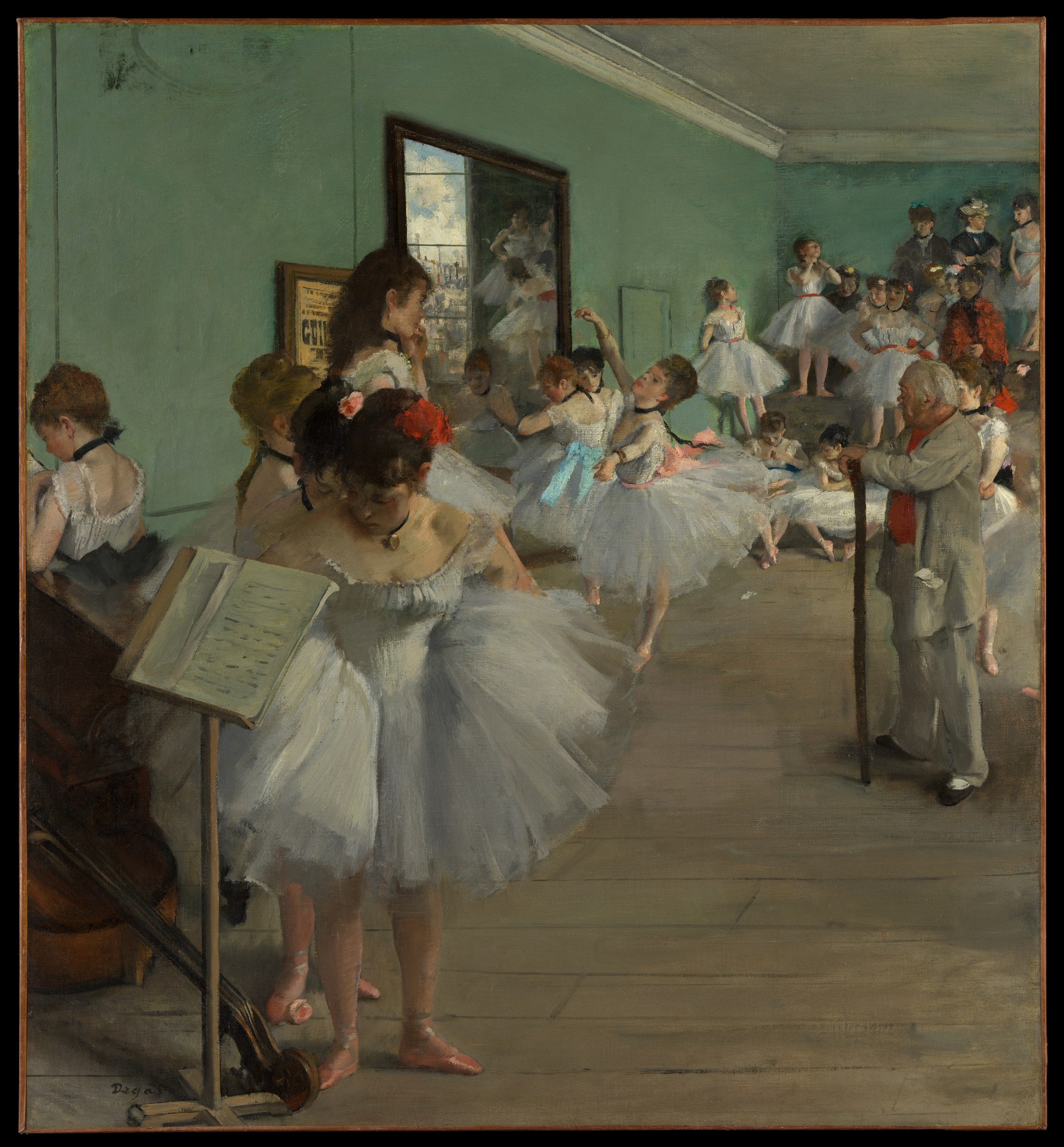 An elderly ballet instructor in a pale suit directs a group of young female dancers in white tutus in a sunlit studio with pale green walls.