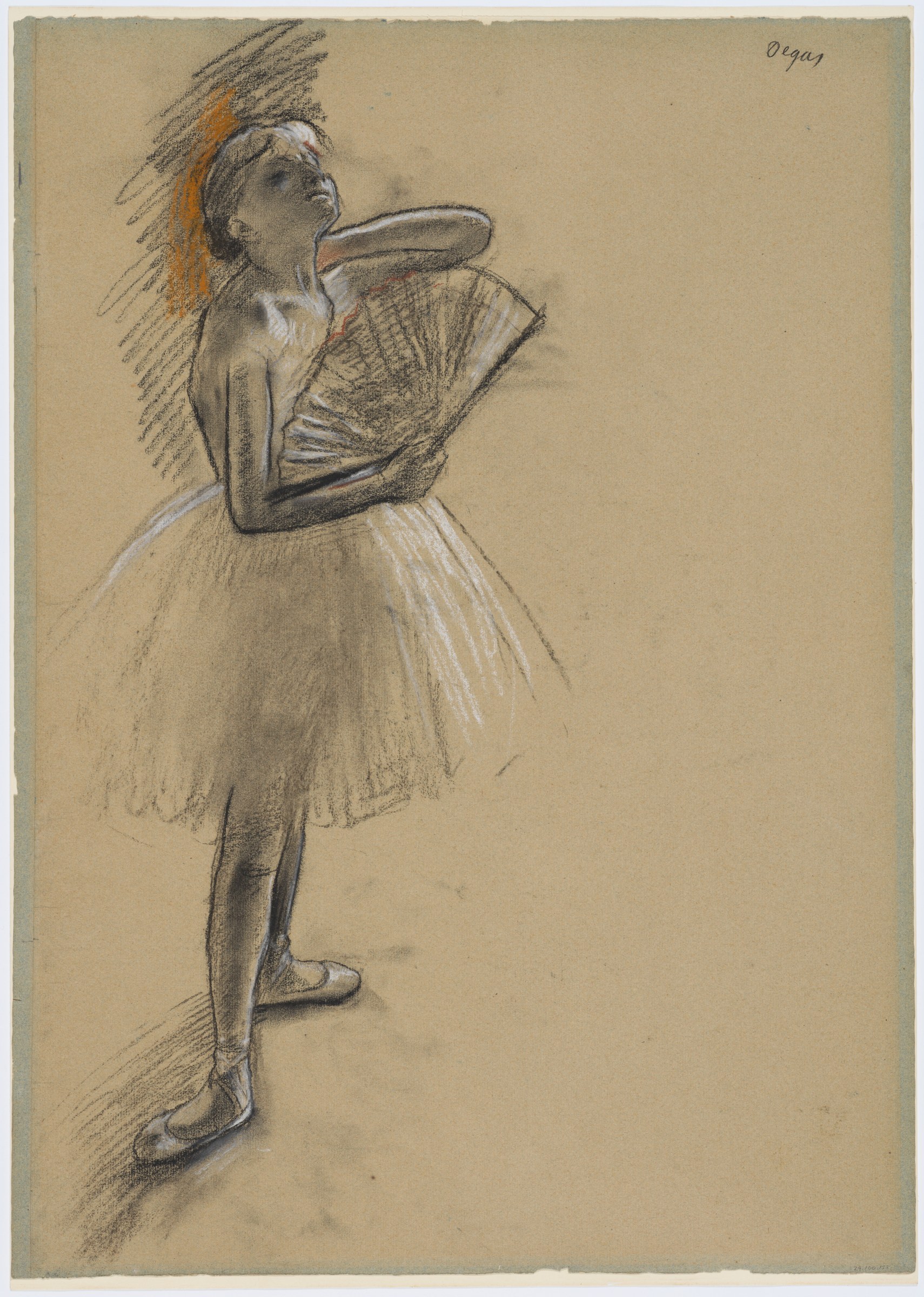 A young ballet dancer in a pale tulle skirt and fitted bodice holds a fan near her face, standing on one leg with the other extended behind her.